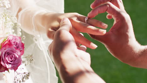 close up of married african american couple putting ring