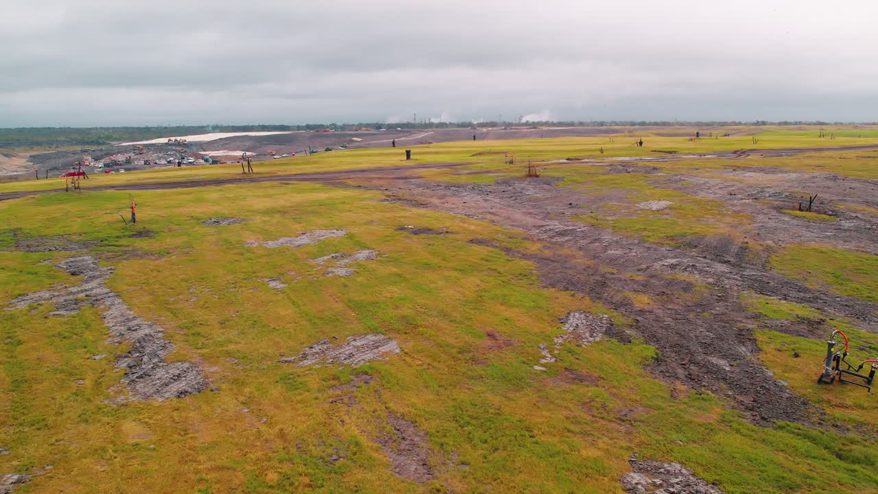 Forward shot of Louisiana landfill with gas wells