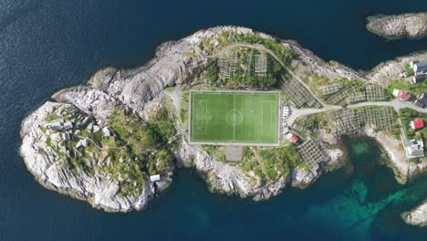 henningsvaer soccer field in lofoten island, norway - aerial top down view