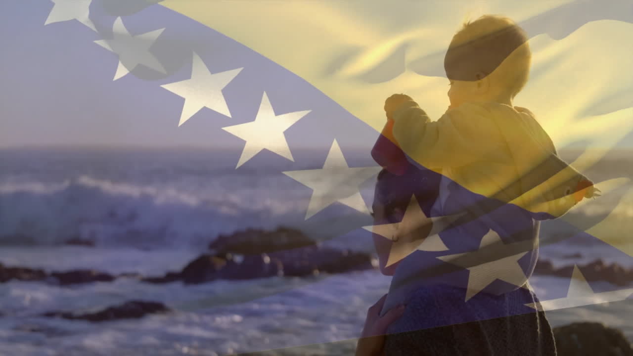 At beach, child on adult's shoulders with Bosnia and Herzegovina flag animation