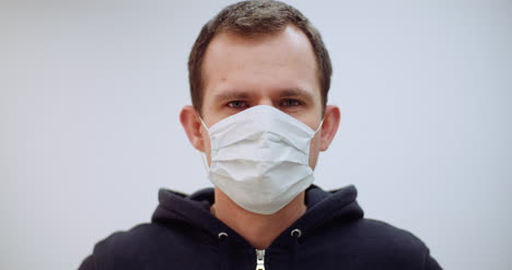 man with coronavirus symptoms wearing protective mask 2