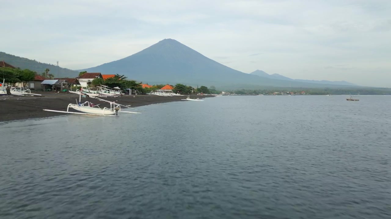 Mount Agung Volcano Cloudy Morning Amed Beach Bali Indonesia Drone Track In Fast Over Ocean 4K 60FPS