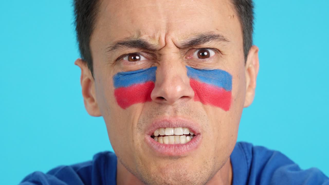 Man with haitian national flag upset with a referee