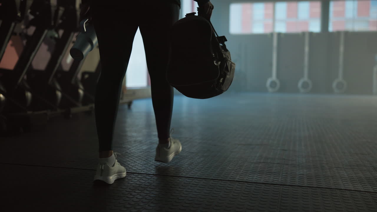 Woman with Gym Bag Walking in Fitness Center