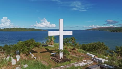 aerial shot of catholic cemetery overlooking bay in surigao del norte, philippines