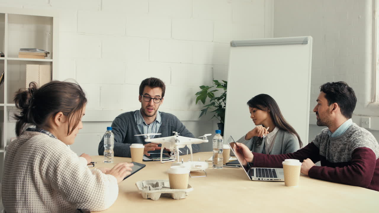 Group of young hipsters discussing drone technology