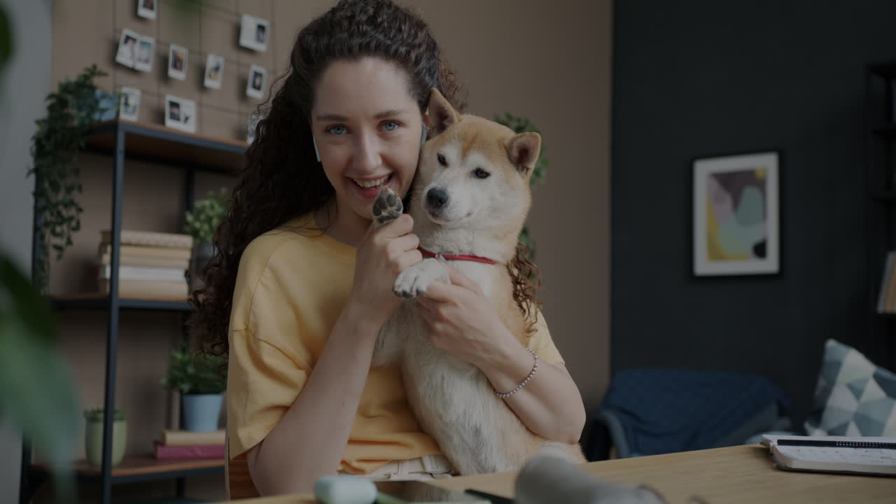 Woman having a video call with her dog