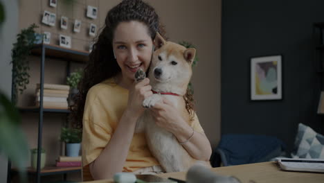 woman having a video call with her dog