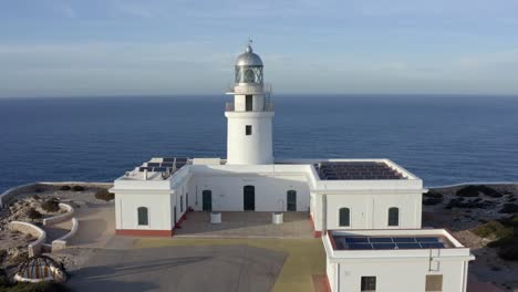 Cinematic-drone-pan-above-Spanish-lighthouse-on-the-coastline-of-Menorca