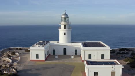 cinematic drone pan above spanish lighthouse on the coastline of menorca