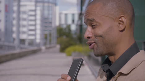 joyful african american man talking on phone