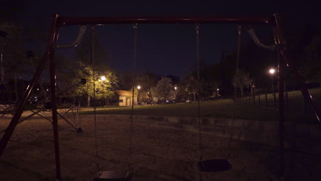 empty swings,climbing bars,playground at night,prague,czechia,during lockdown