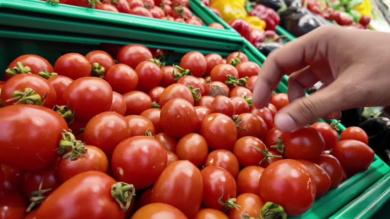 Person buying cherry tomatoes at a grocery store