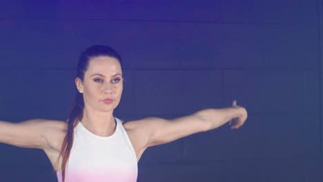 Young-female-contemporary-dancer-performing-in-smoky-urban-studio-interior,-Mid-shot