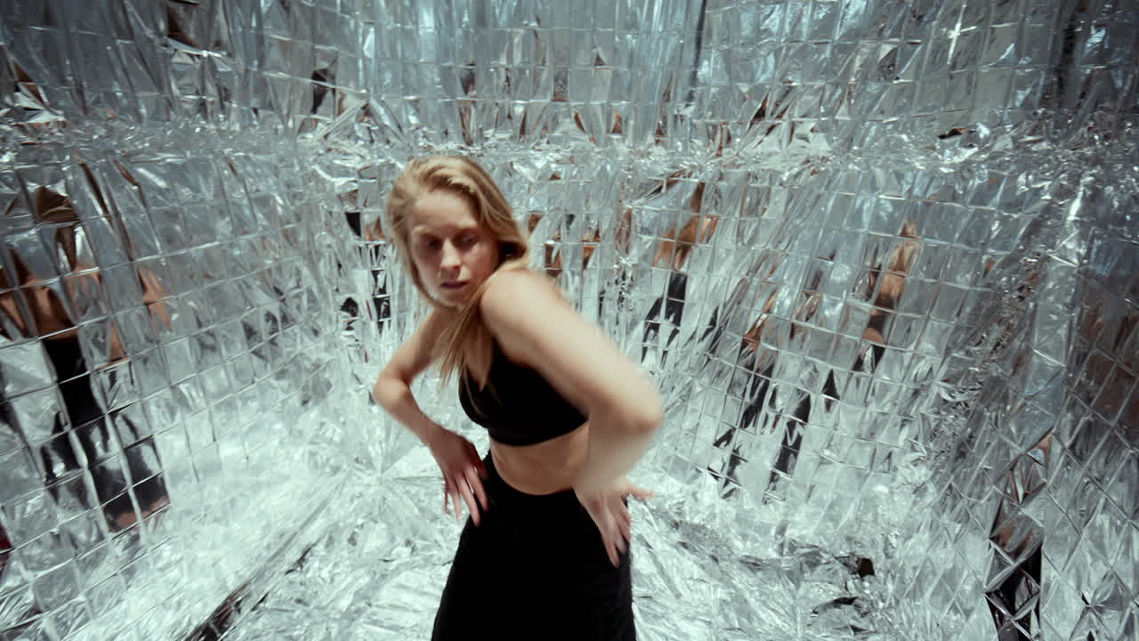 Young Woman Performing Sensual Contemporary Dance in Silver Room