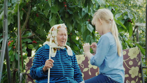 granddaughter shows her grandmother's handmade clay products communion of generations concept