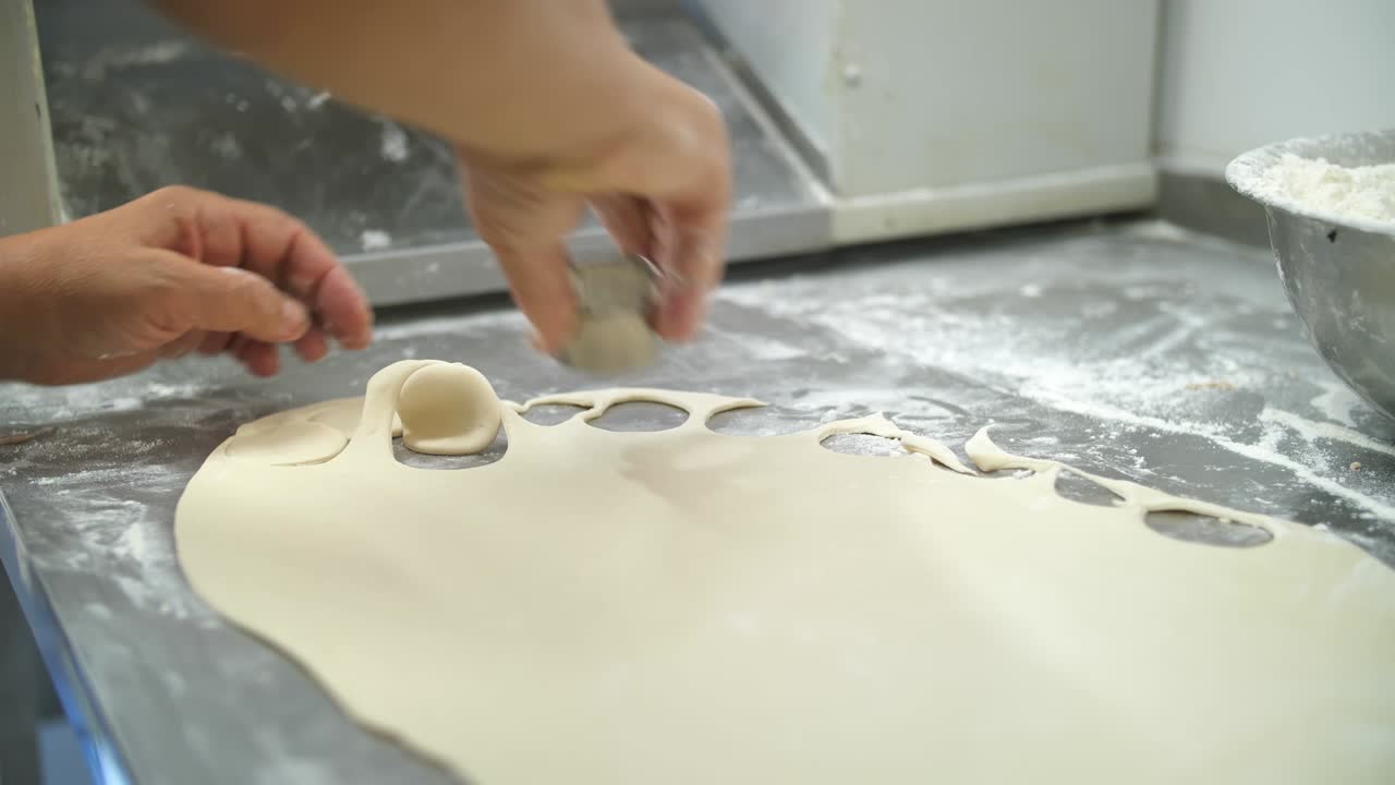 dumplings, ravioli. dough for dumplings. Close-up. Cutting out circles from raw dough
