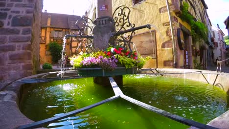 dramatic slow motion video of a historic fountain in an old french town