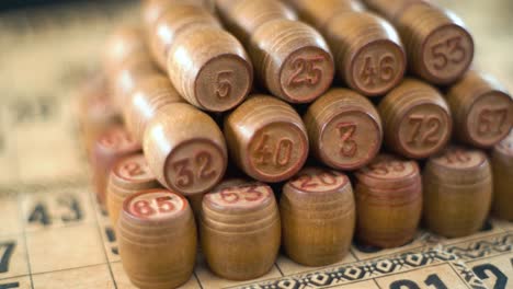 cinematic creative smooth dreamy macro shot of bingo wooden barrels in a row, woody figures, old numbers background, vintage board game, slow motion 120 fps commercial gimbal video, crane movement