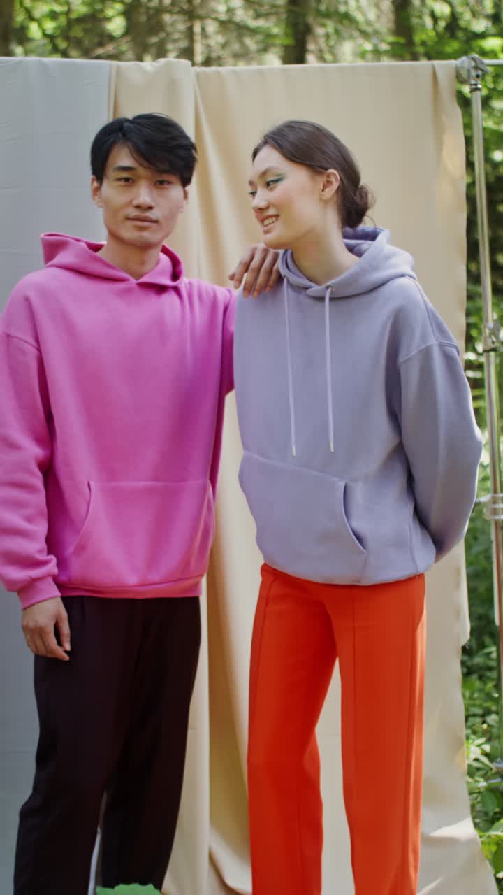 People wearing hoodies in a forest setting