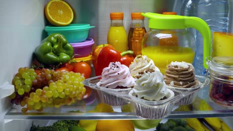 Sweet-cakes-in-the-open-refrigerator.