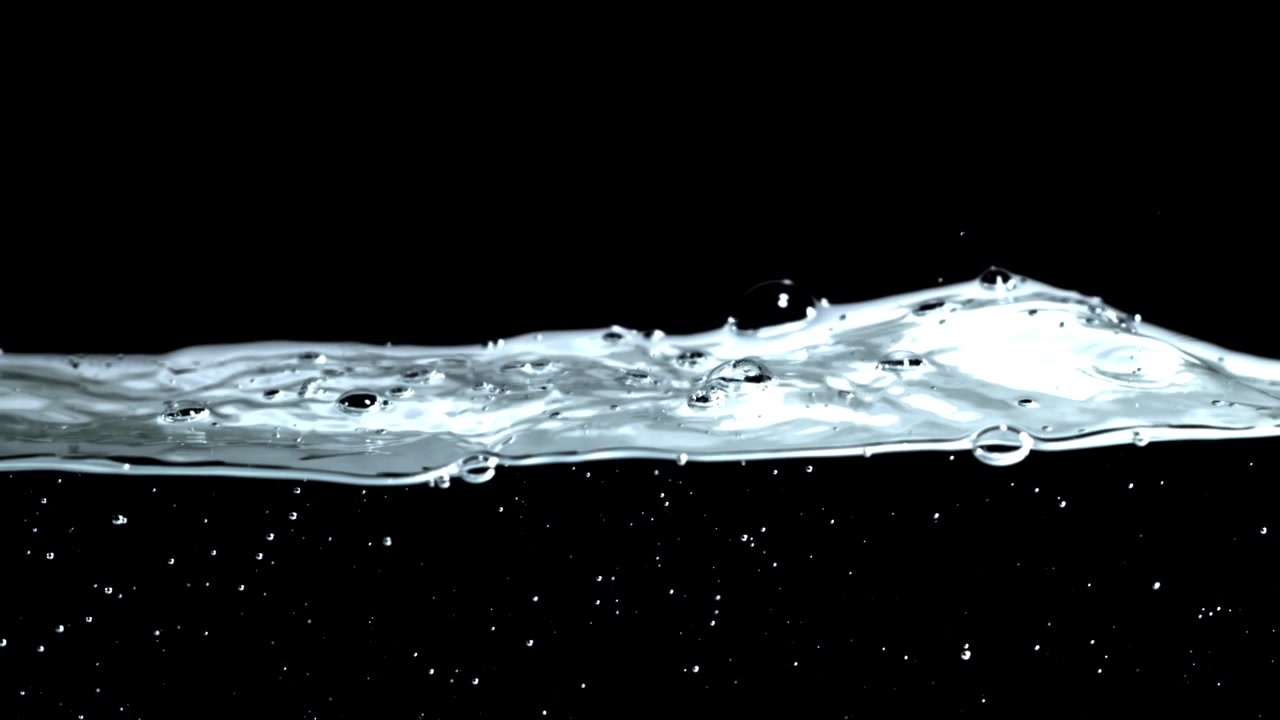 Dynamic Clear Water Surface with Bubbles Against Black Background