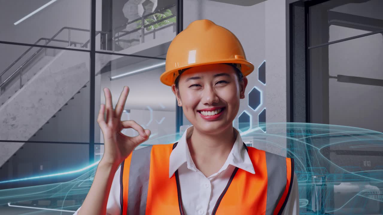 웃는 여성 엔지니어가 현대 사무실 공간에서 ok 표지판을 보여줍니다.