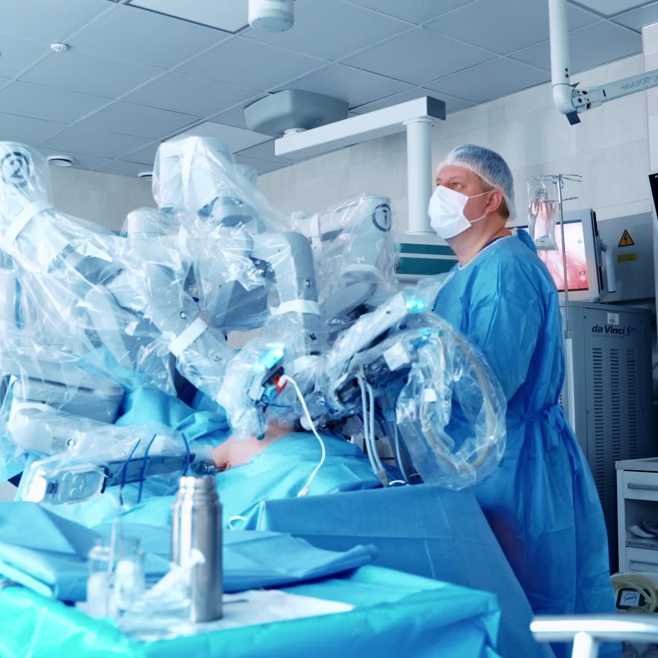 Da Vinci Surgical System. Minimally invasive robotic surgery. Team surgeon at work in operating room.