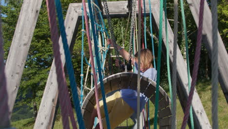 child playing on a rope playground