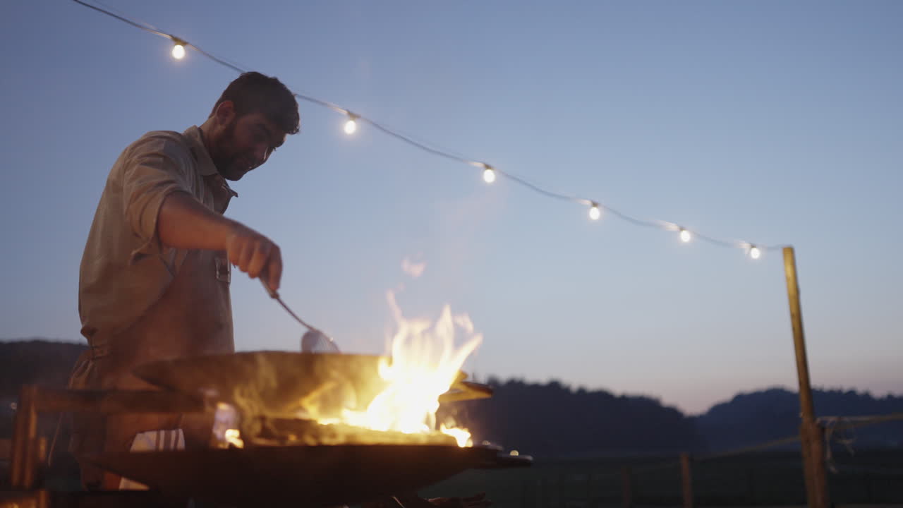 Man Cooking Outdoors at Night