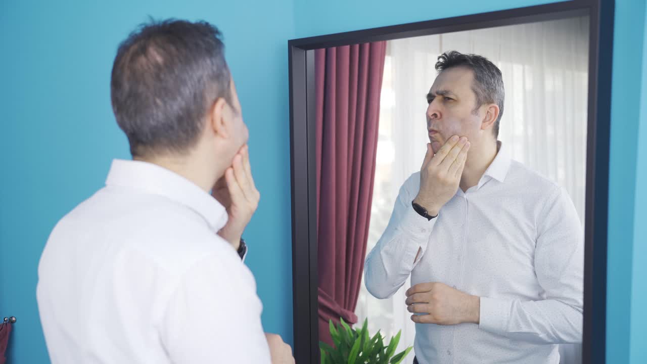 The man who doesn't like himself in the mirror.