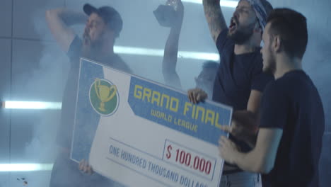 Gaming Tournament Team Celebrating their Victory Medium Shot of a Gaming Tournament Team Holding their Prize while Celebrating their Victory