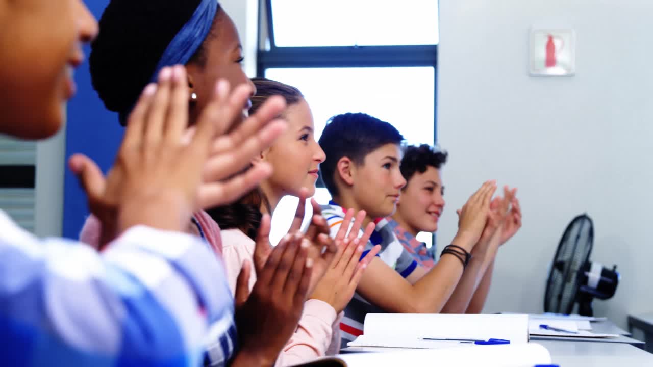 Student applauding in classroom