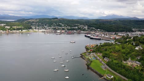 aerial footage of a scottish ferry arriving in a port, oban, scotland, united kingdom