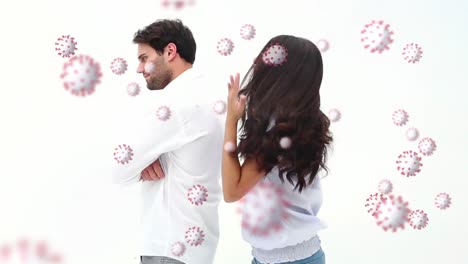 Digital-composite-video-of-Covid-19-cells-moving-against-couple-having-a-fight-in-background