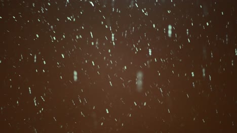 snow falling against dark background of sky in the night