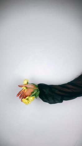 woman holding yellow flowers