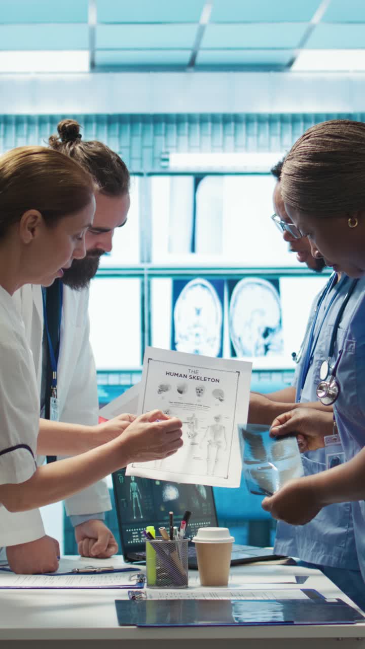 Vertical Video Hospital staff reviews human anatomy to give the correct diagnostic