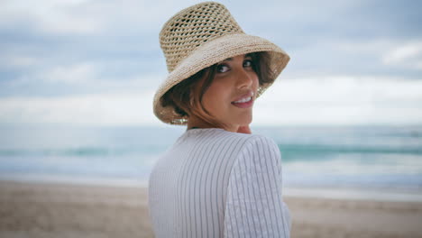 sensual brunette posing beach at cloudy ocean closeup. smiling lady enjoy shore