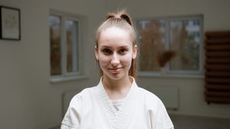 caucasian female teacher in white kimono in martial arts class