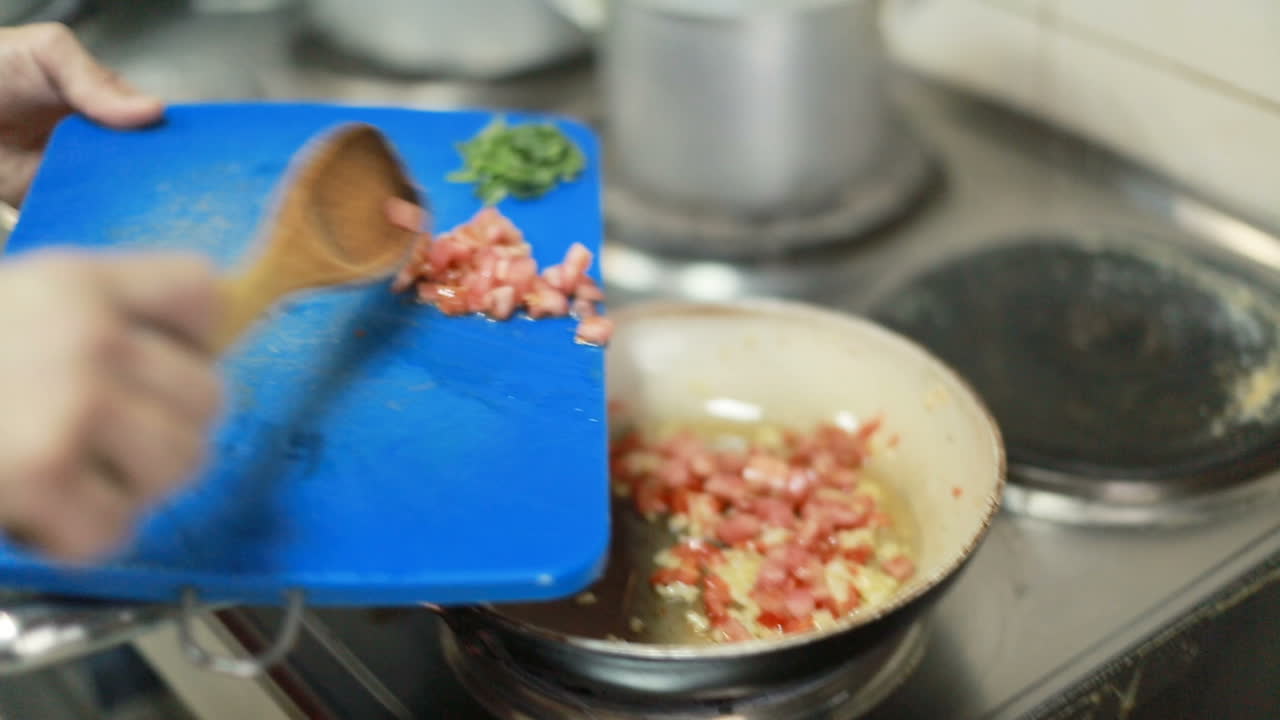 Professional Kitchen, Preparing Dinner. Chef in restaurant kitchen at stove with pan