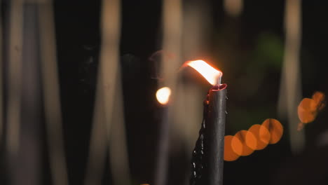 close-up of a burning candle in the night