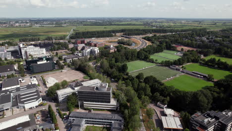 panorama of groningenweg 8 with sports complex near industrial site in gouda city, the netherlands