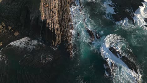 Rocky-reefs-on-coast-of-Atlantic-ocean-in-Portugal,-top-down-drone-aerial-view-of-rough-sea-water