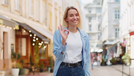 young woman looking approvingly at camera showing ok gesture positive like sign okay celebrate win