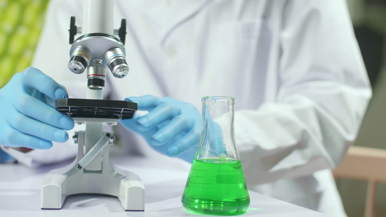 Closeup Of Biologist Hands Using Microscope Analyzing Genetic Mutation On Plant. Chemist Specialist Examining Gmo Test While Working In Pharmaceutical Lab At Ecology Expertise