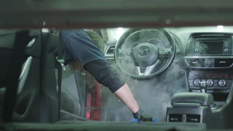 professional car cleaning. сar wash. interior detailing. dry clean and detail a car interior. deep seats cleaning. wiping foam in car wash. cleaning the car panel from dust. a vacuum cleaner