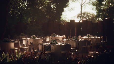 outdoor wedding reception with white tables and chairs in a garden setting