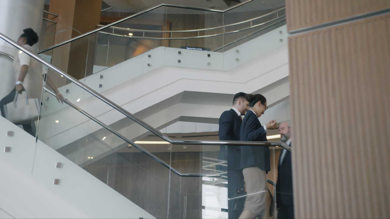 Business People Walking Upstairs in Modern Office Building