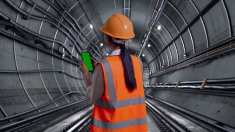 engineer in a tunnel using smartphone